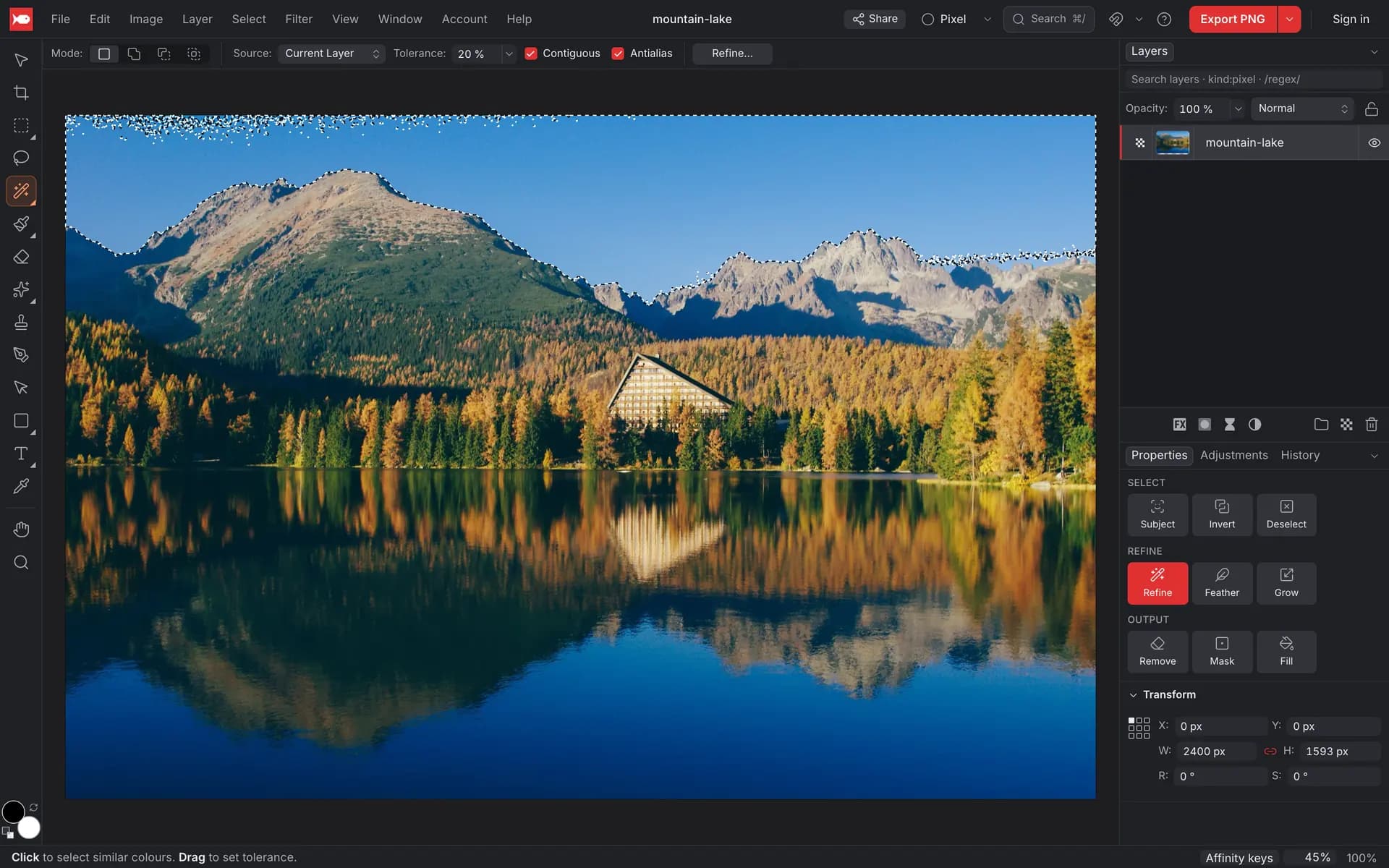 A mountain lake photo where one click with Flood Select has selected the blue sky, outlined with marching ants along the mountain ridge